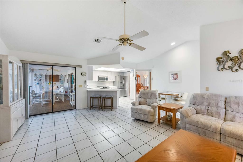 10534 Alpaca Circle Port Charlotte, FL 33981 - Photo 11 of 67 a living room with furniture a fireplace and a chandelier