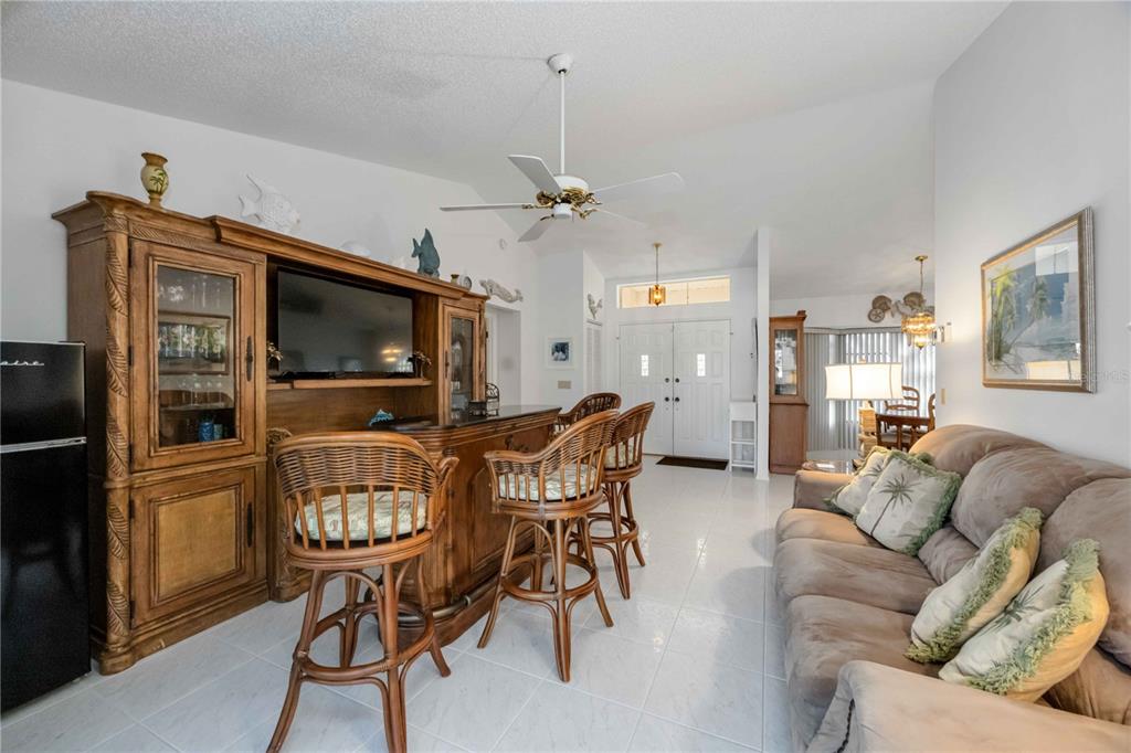 10534 Alpaca Circle Port Charlotte, FL 33981 - Photo 13 of 67 a living room with furniture a flat screen tv and kitchen view