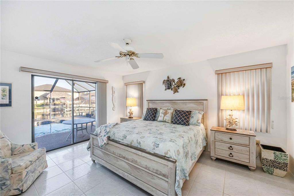 10534 Alpaca Circle Port Charlotte, FL 33981 - Photo 30 of 67 a bedroom with a bed and large windows