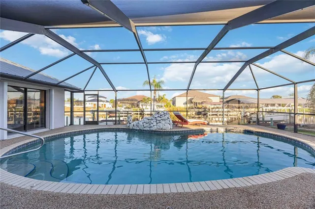 a view of a swimming pool with lawn chairs