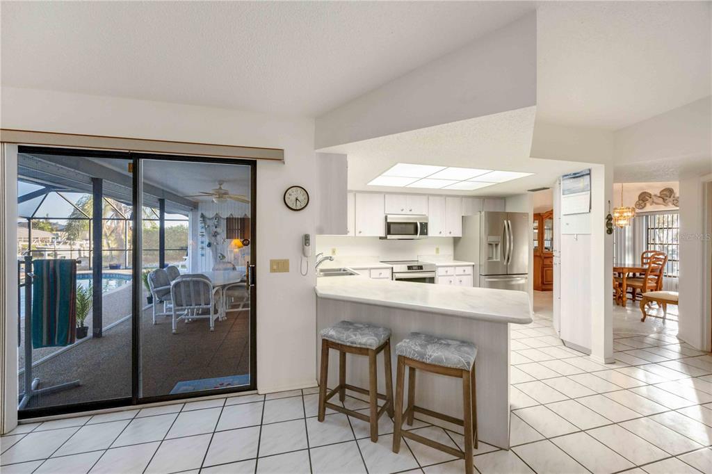 10534 Alpaca Circle Port Charlotte, FL 33981 - Photo 4 of 67 a kitchen with stainless steel appliances granite countertop a refrigerator and a stove top oven