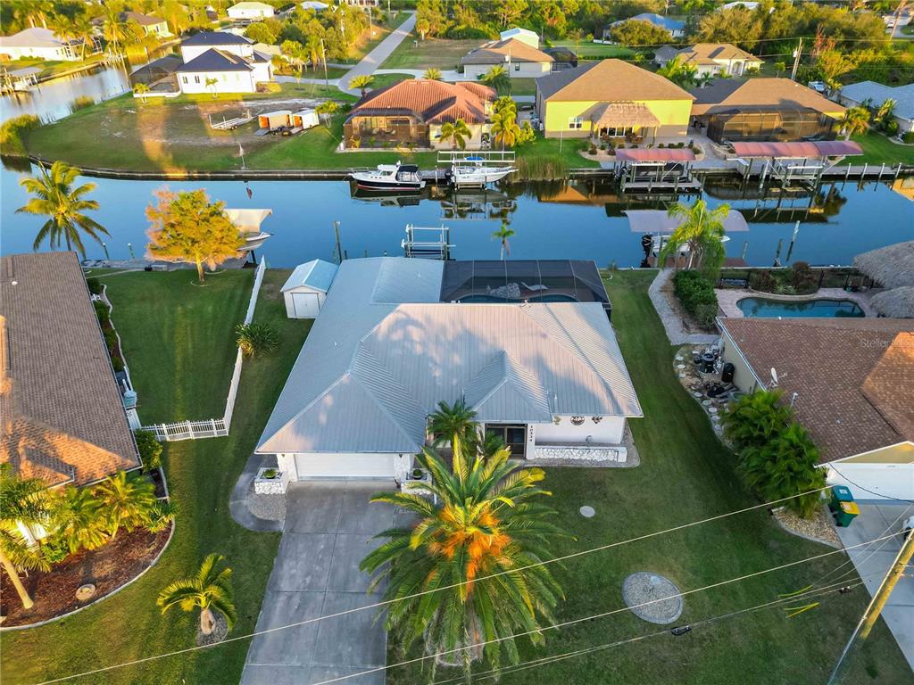 10534 Alpaca Circle Port Charlotte, FL 33981 - Photo 54 of 67 an aerial view of a pool patio fire pit and outdoor kitchen