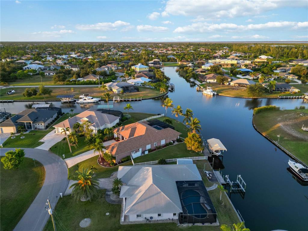 10534 Alpaca Circle Port Charlotte, FL 33981 - Photo 59 of 67 an aerial view of residential houses with outdoor space and lake view