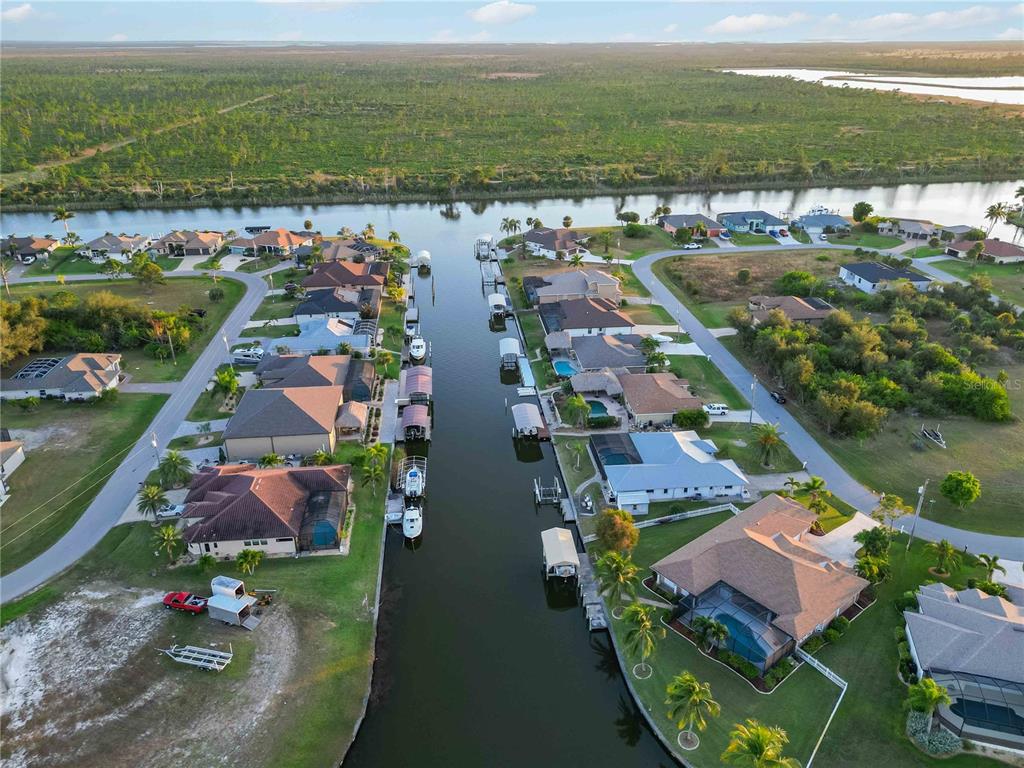 10534 Alpaca Circle Port Charlotte, FL 33981 - Photo 65 of 67 an aerial view of residential houses with outdoor space and river