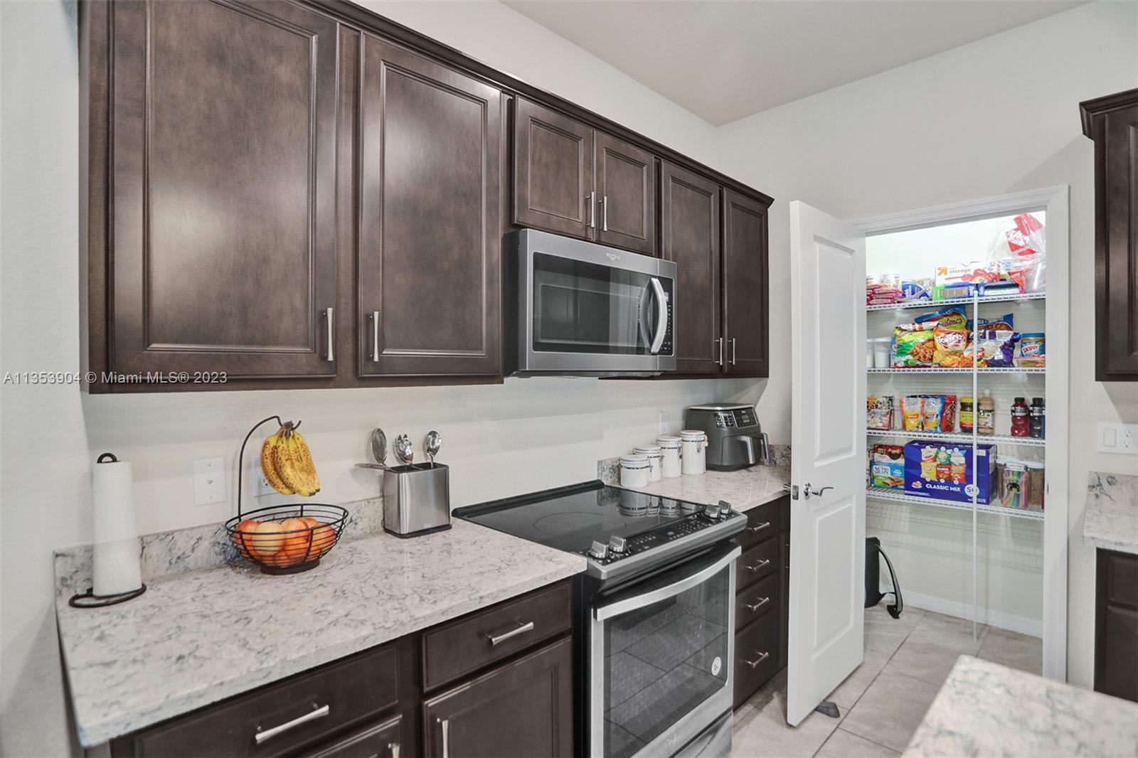 4764 Eucalyptus Drive, Unit 4764 Hollywood, FL 33021 - Photo 12 of 54 a kitchen with stainless steel appliances granite countertop a sink and a microwave