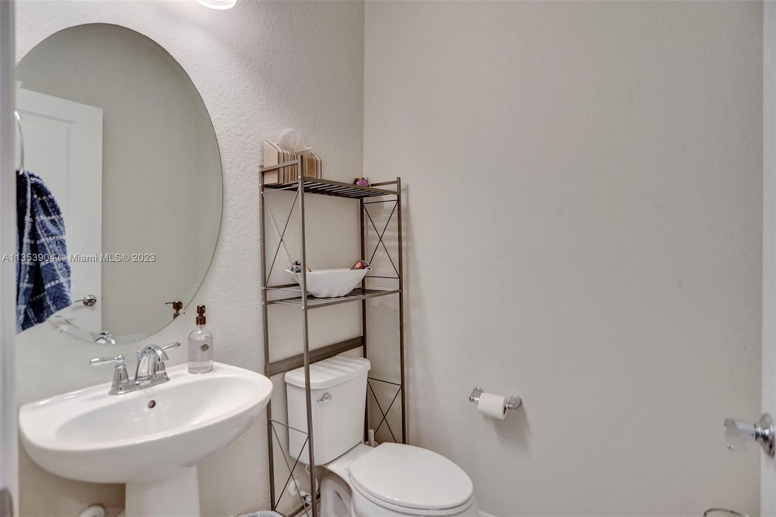 4764 Eucalyptus Drive, Unit 4764 Hollywood, FL 33021 - Photo 23 of 54 a bathroom with a toilet sink and mirror