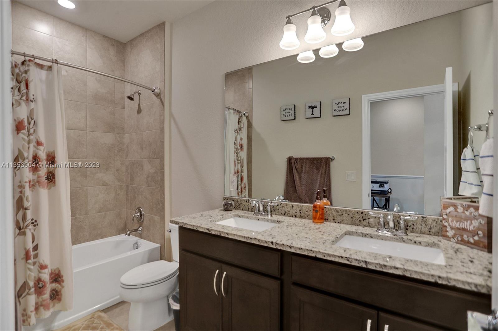 4764 Eucalyptus Drive, Unit 4764 Hollywood, FL 33021 - Photo 32 of 54 a bathroom with a double vanity sink mirror double toilet and shower
