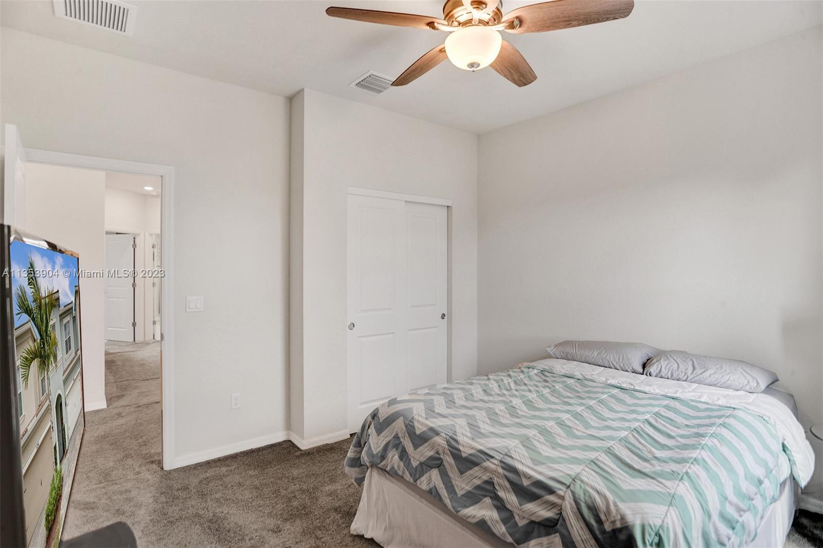 4764 Eucalyptus Drive, Unit 4764 Hollywood, FL 33021 - Photo 35 of 54 a bedroom with a bed and a chandelier