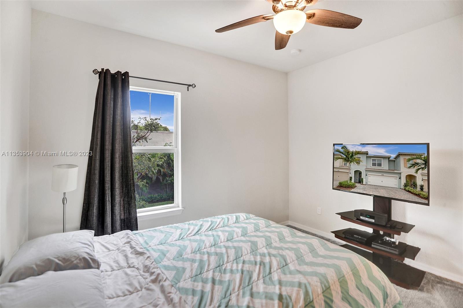4764 Eucalyptus Drive, Unit 4764 Hollywood, FL 33021 - Photo 36 of 54 a bedroom with a bed and a chandelier