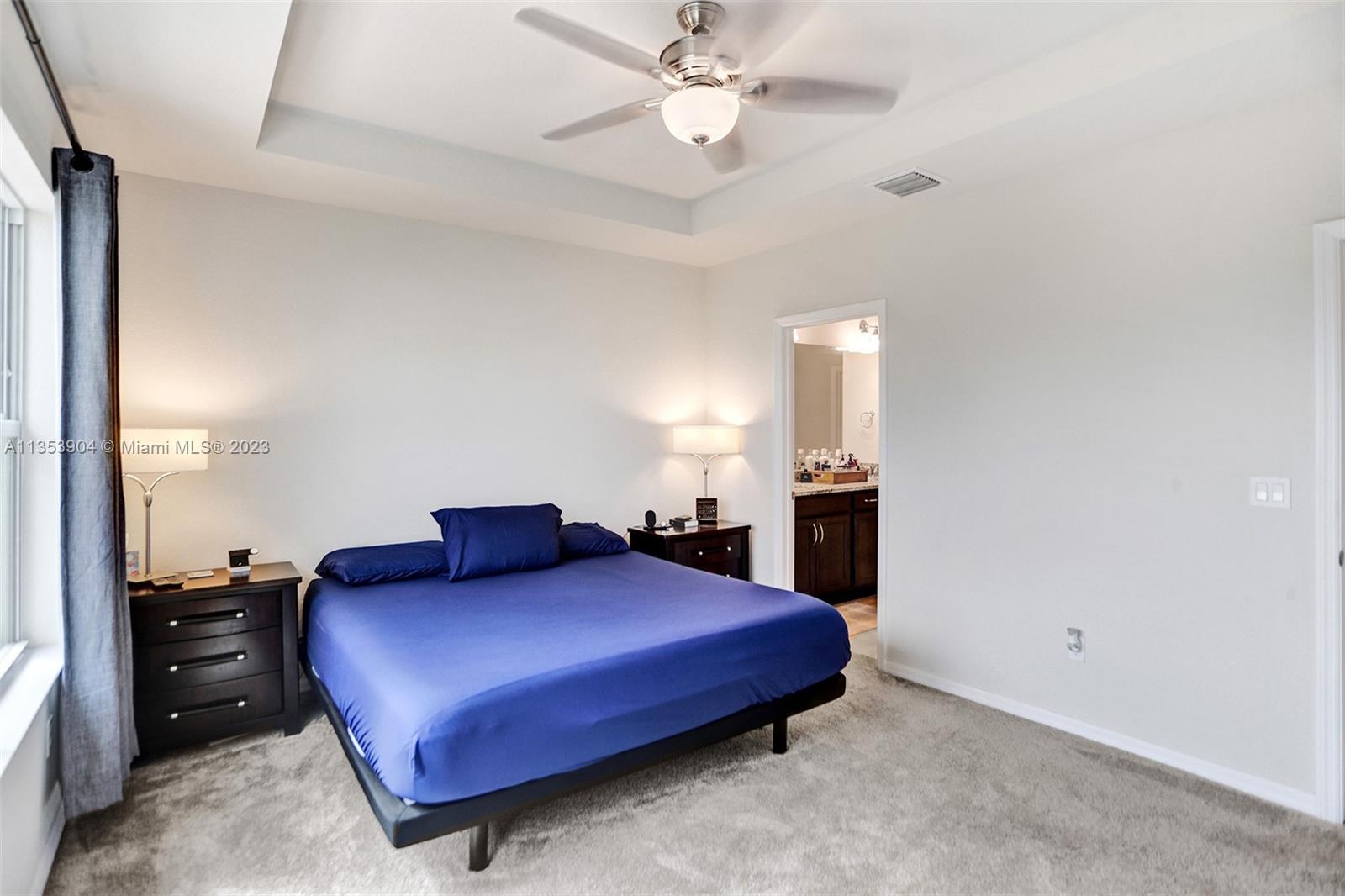 4764 Eucalyptus Drive, Unit 4764 Hollywood, FL 33021 - Photo 38 of 54 a bedroom with a bed and a chandelier