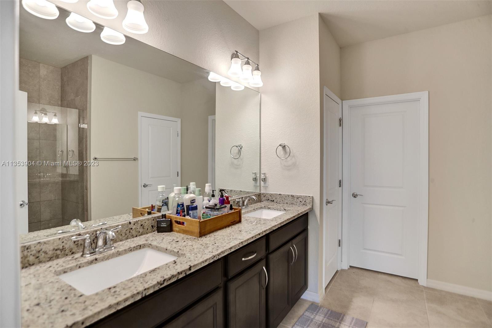 4764 Eucalyptus Drive, Unit 4764 Hollywood, FL 33021 - Photo 41 of 54 a bathroom with a sink double vanity and a mirror