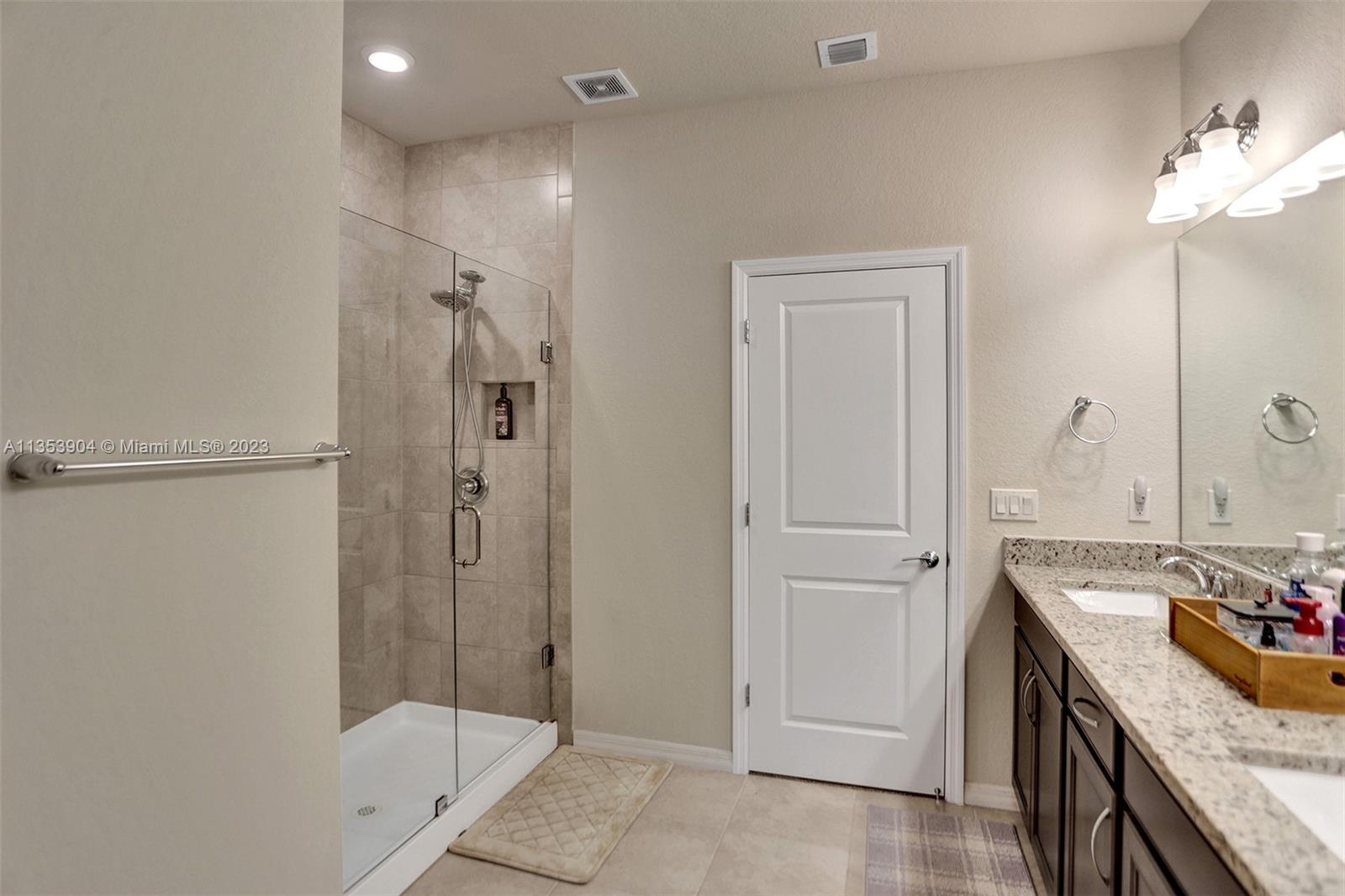 4764 Eucalyptus Drive, Unit 4764 Hollywood, FL 33021 - Photo 43 of 54 a bathroom with a granite countertop sink a shower and a mirror