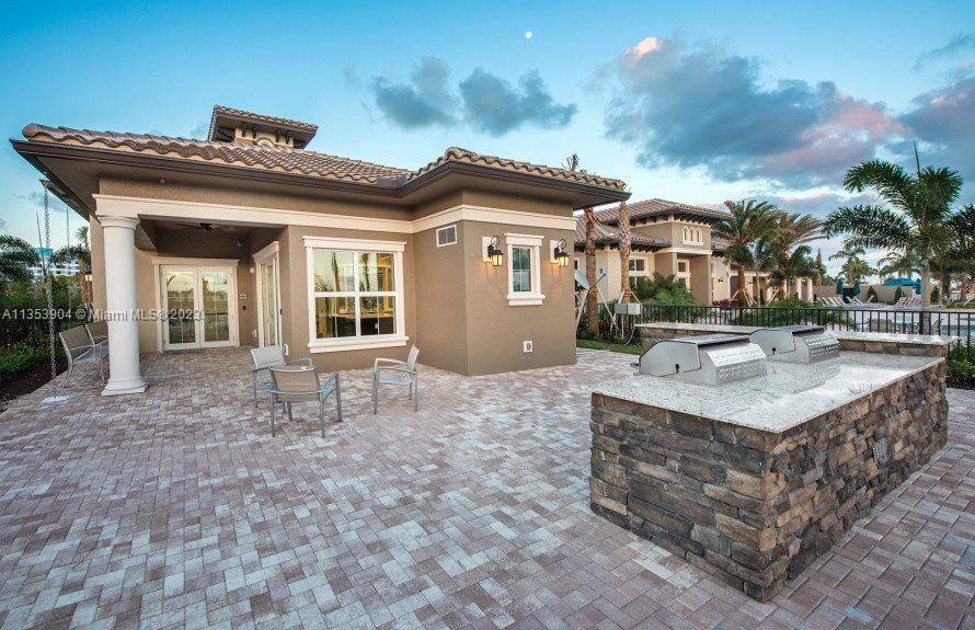 4764 Eucalyptus Drive, Unit 4764 Hollywood, FL 33021 - Photo 52 of 54 a view of a house with a patio and a yard