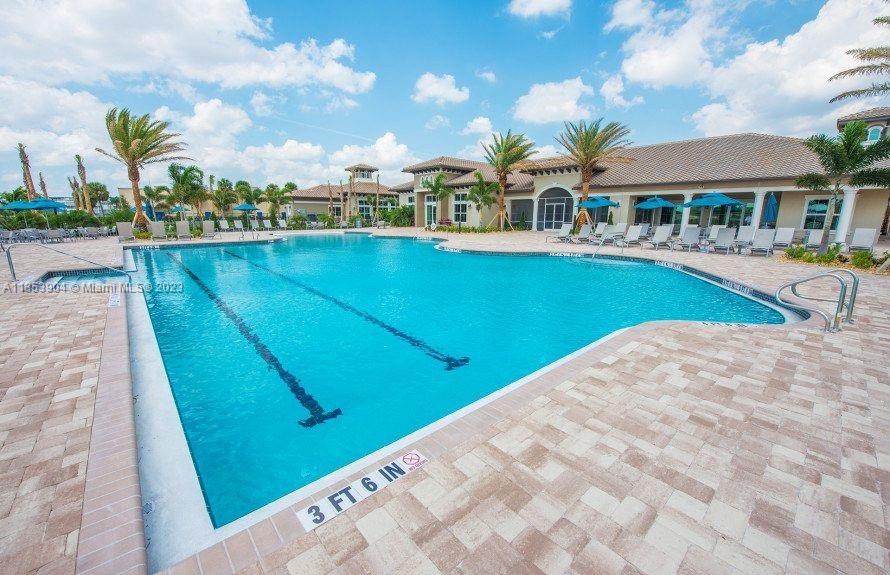4764 Eucalyptus Drive, Unit 4764 Hollywood, FL 33021 - Photo 53 of 54 a view of swimming pool that has lawn chairs with plants