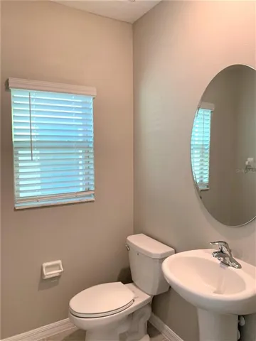 en suite bathroom with a toilet sink and mirror