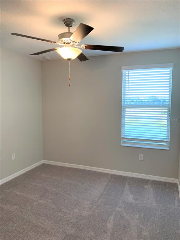 4412 Summer Savory Street Tampa, FL 33619 - Photo 18 of 40 a view of a small space with a window and a fan