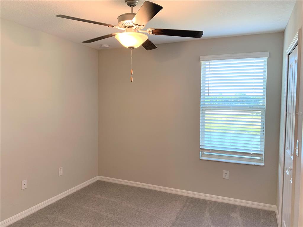 4412 Summer Savory Street Tampa, FL 33619 - Photo 19 of 40 an empty room with a window and a fan