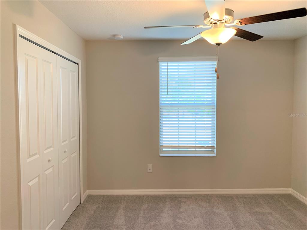 4412 Summer Savory Street Tampa, FL 33619 - Photo 20 of 40 an empty room with windows and fan