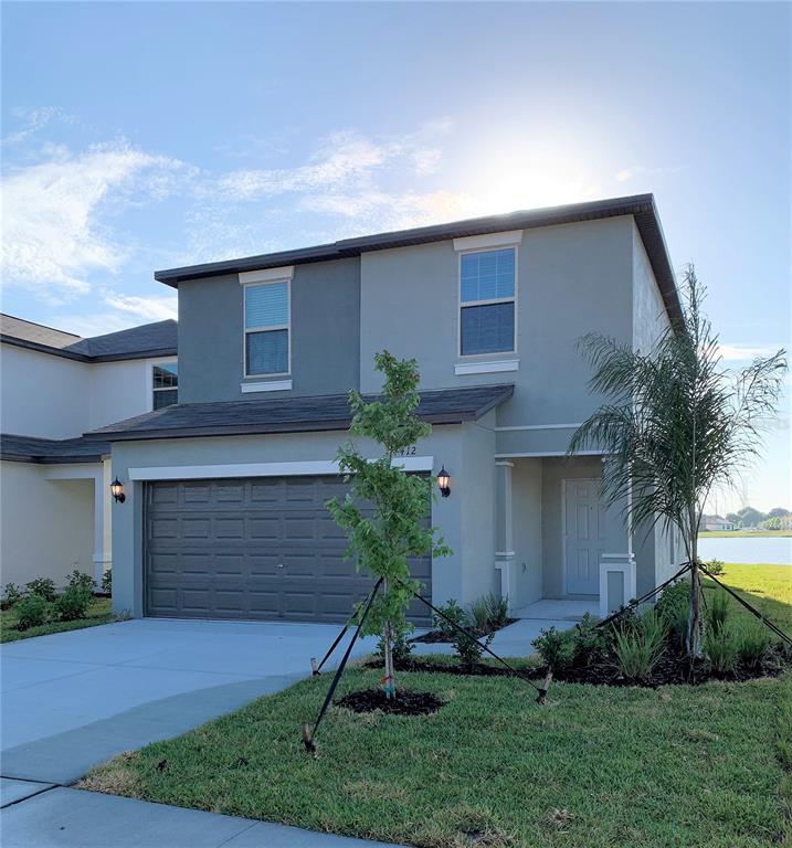 4412 Summer Savory Street Tampa, FL 33619 - Photo 2 of 40 a front view of a house with garden