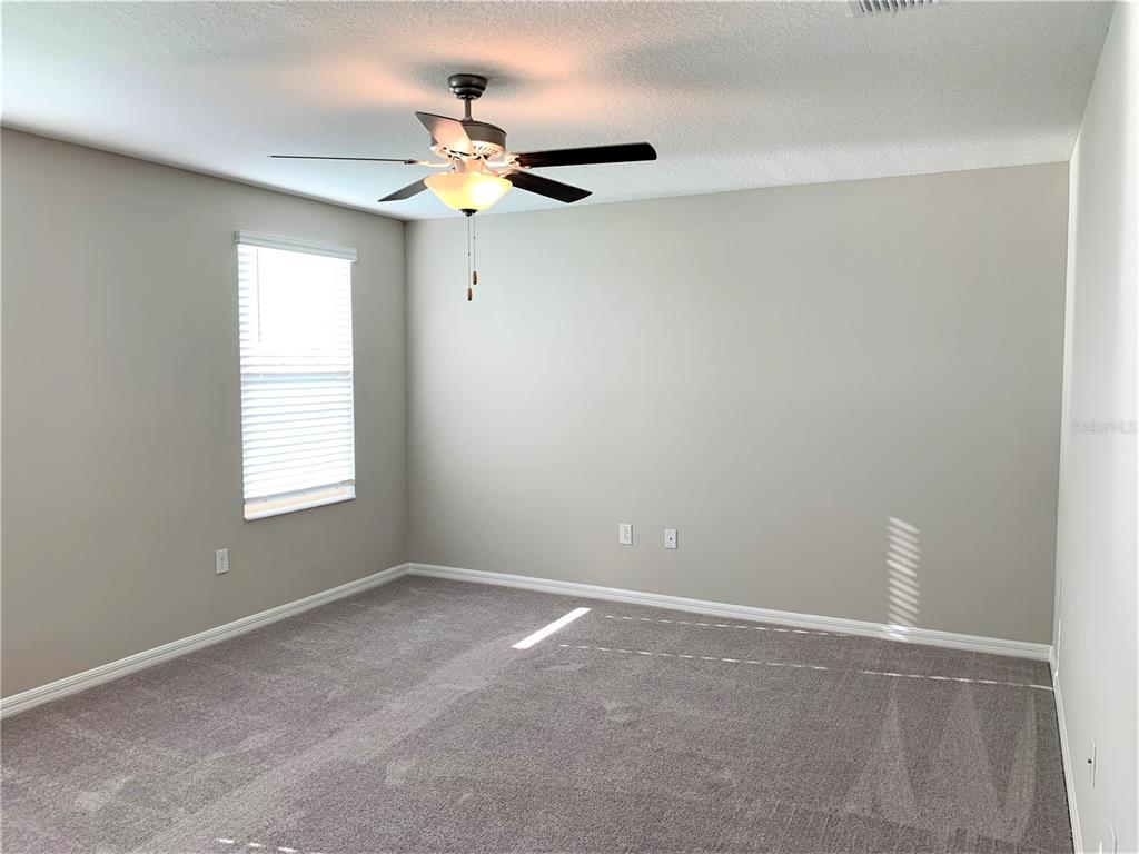 4412 Summer Savory Street Tampa, FL 33619 - Photo 25 of 40 a view of an empty room with a window