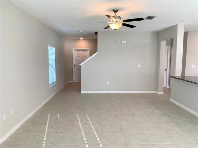 a view of an empty room with a ceiling fan