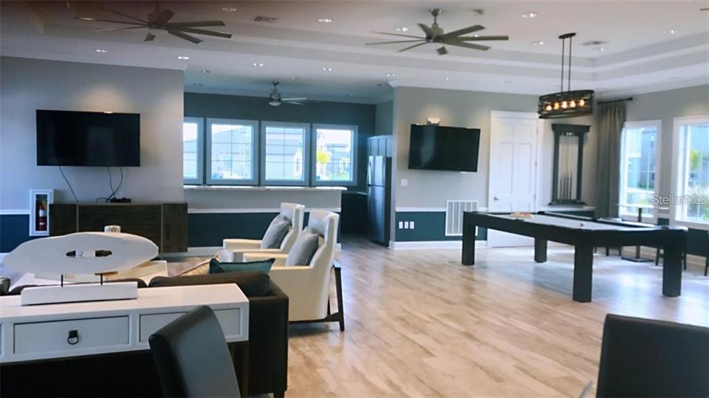 4412 Summer Savory Street Tampa, FL 33619 - Photo 32 of 40 a living room with furniture and a flat screen tv