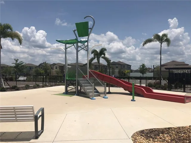 a view of a hallway with wooden floor and livingroom