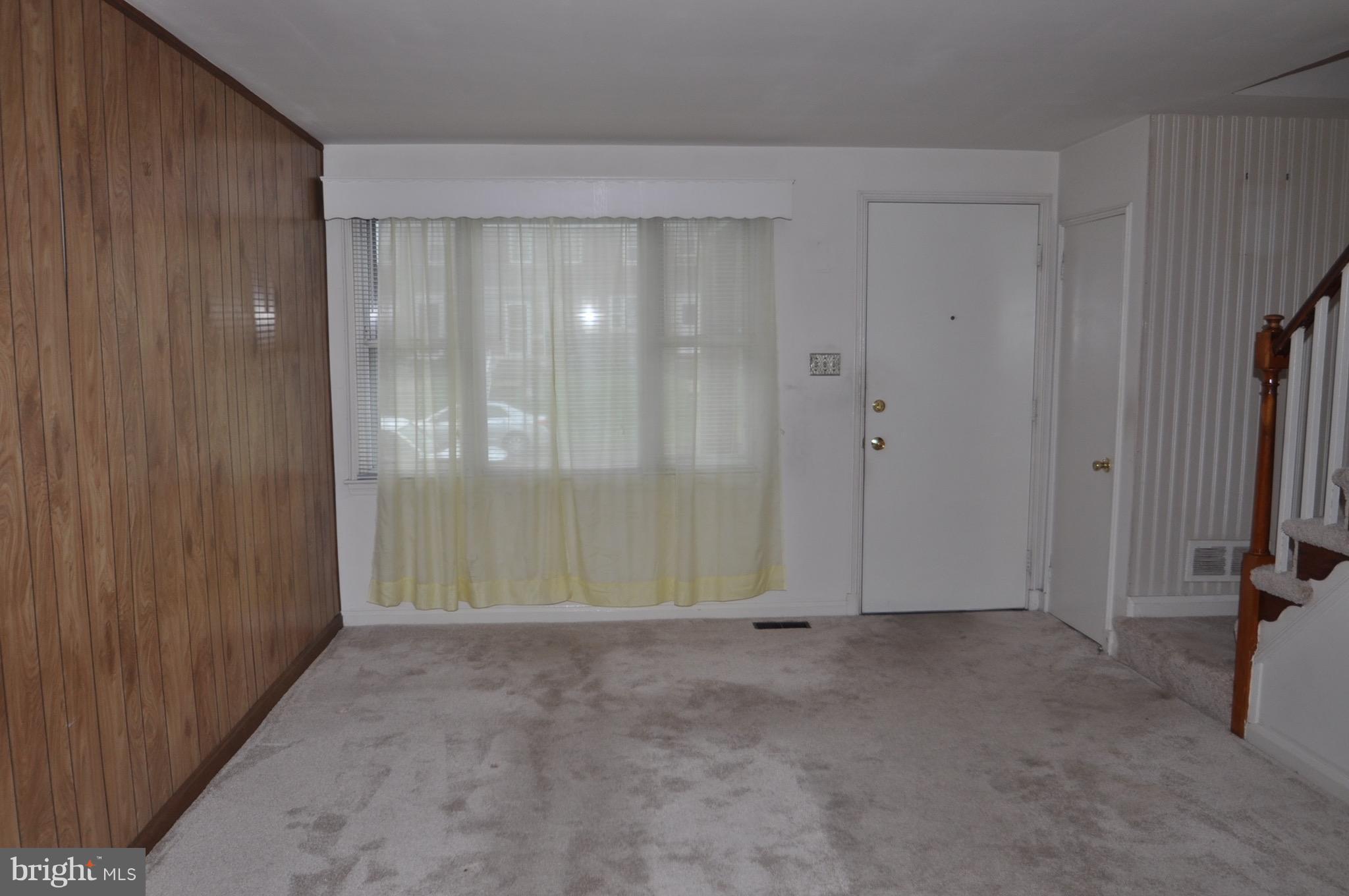 7438 Durwood Road Baltimore, MD 21222 - Photo 3 of 20 a view of an empty room with a door