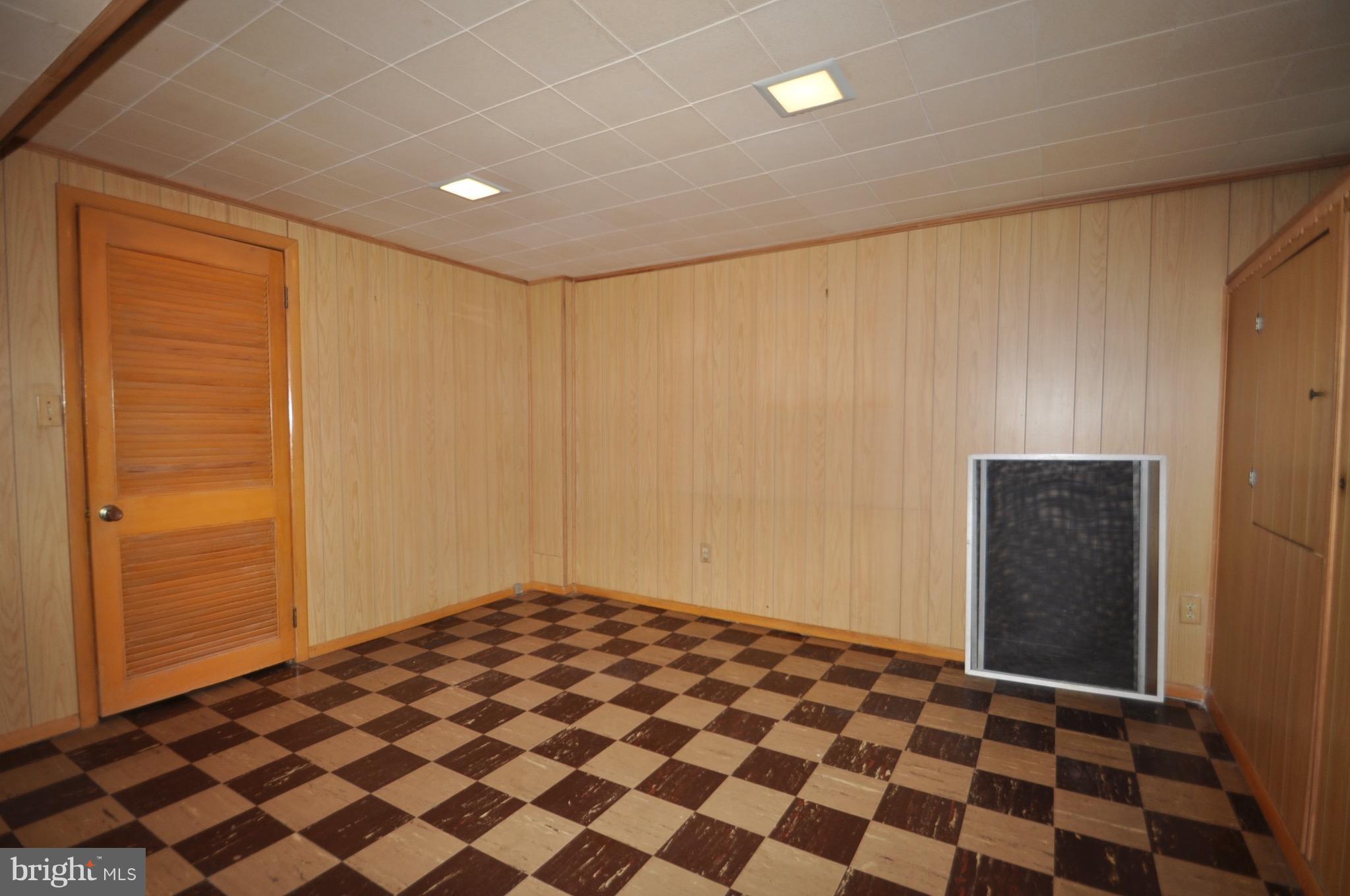 7438 Durwood Road Baltimore, MD 21222 - Photo 10 of 20 a view of a big room with a black door and a white door