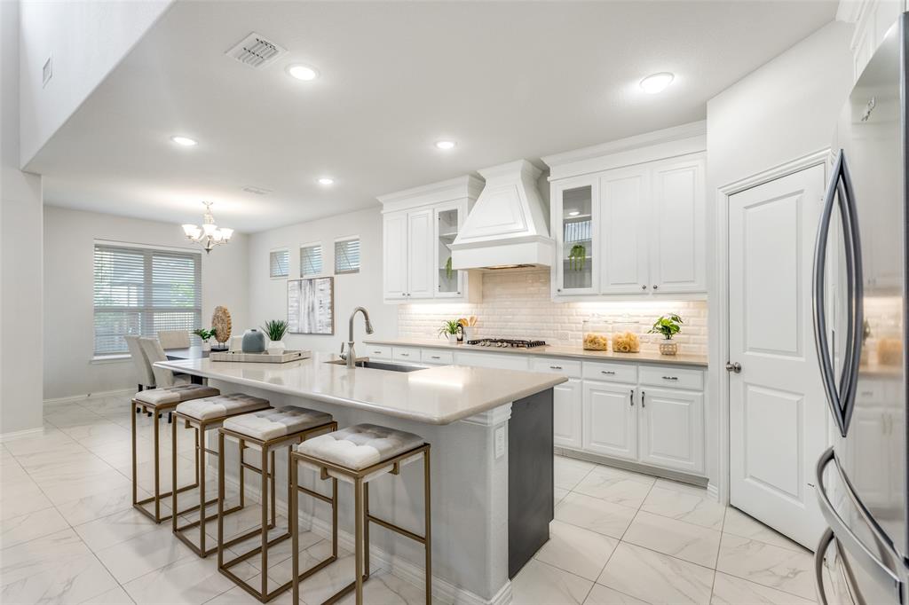 2176 Olive Branch Road Frisco, TX 75033 - Photo 1 of 35 a kitchen with stainless steel appliances granite countertop a table chairs sink and cabinets