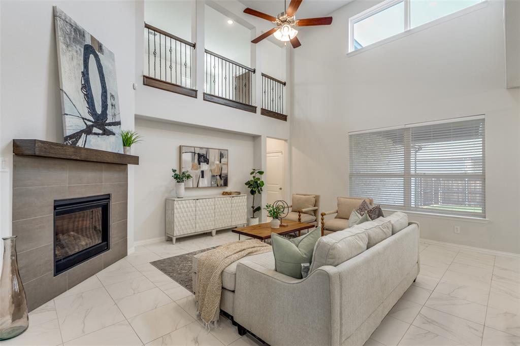 2176 Olive Branch Road Frisco, TX 75033 - Photo 12 of 35 a living room with furniture a fireplace and a flat screen tv
