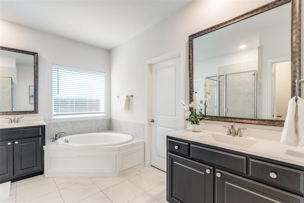 2176 Olive Branch Road Frisco, TX 75033 - Photo 15 of 35 a bathroom with a tub sink and mirror