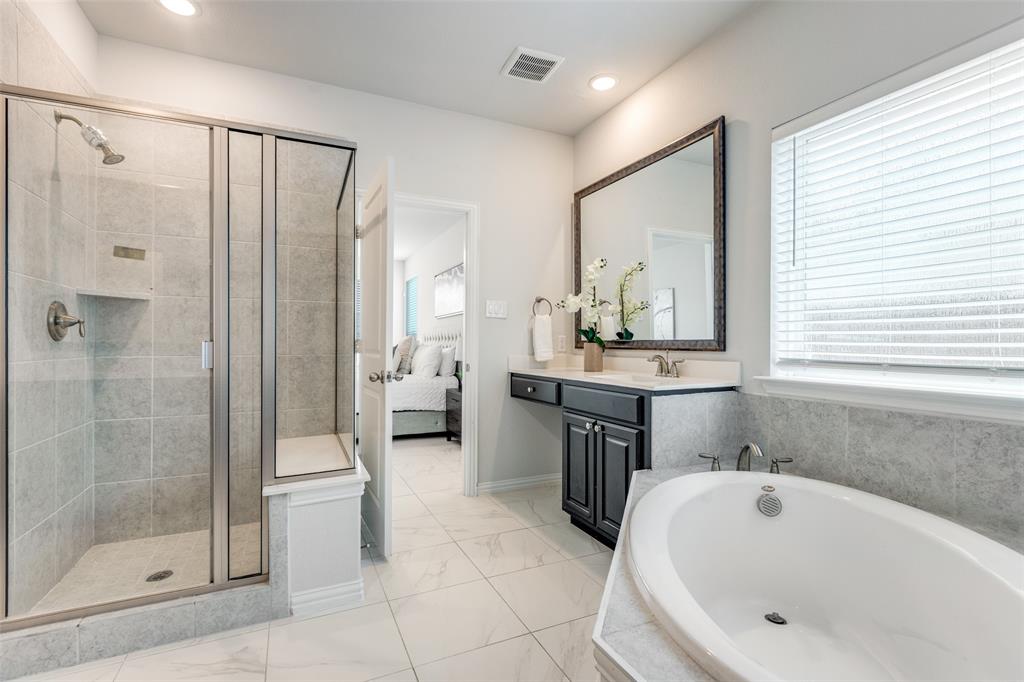 2176 Olive Branch Road Frisco, TX 75033 - Photo 16 of 35 a bathroom with a tub sink and mirror