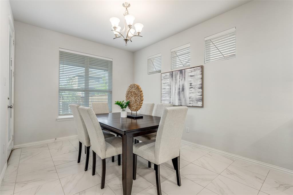 2176 Olive Branch Road Frisco, TX 75033 - Photo 6 of 35 a view of a dining room with furniture and chandelier