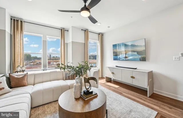 a living room with furniture and a large window