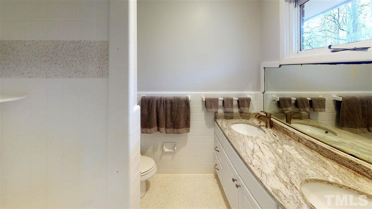 108 Rand Road Raleigh, NC 27603 - Photo 9 of 29 Dual vanity gives everyone some private space. This bathroom has fabulous tile shower and tile floor.
