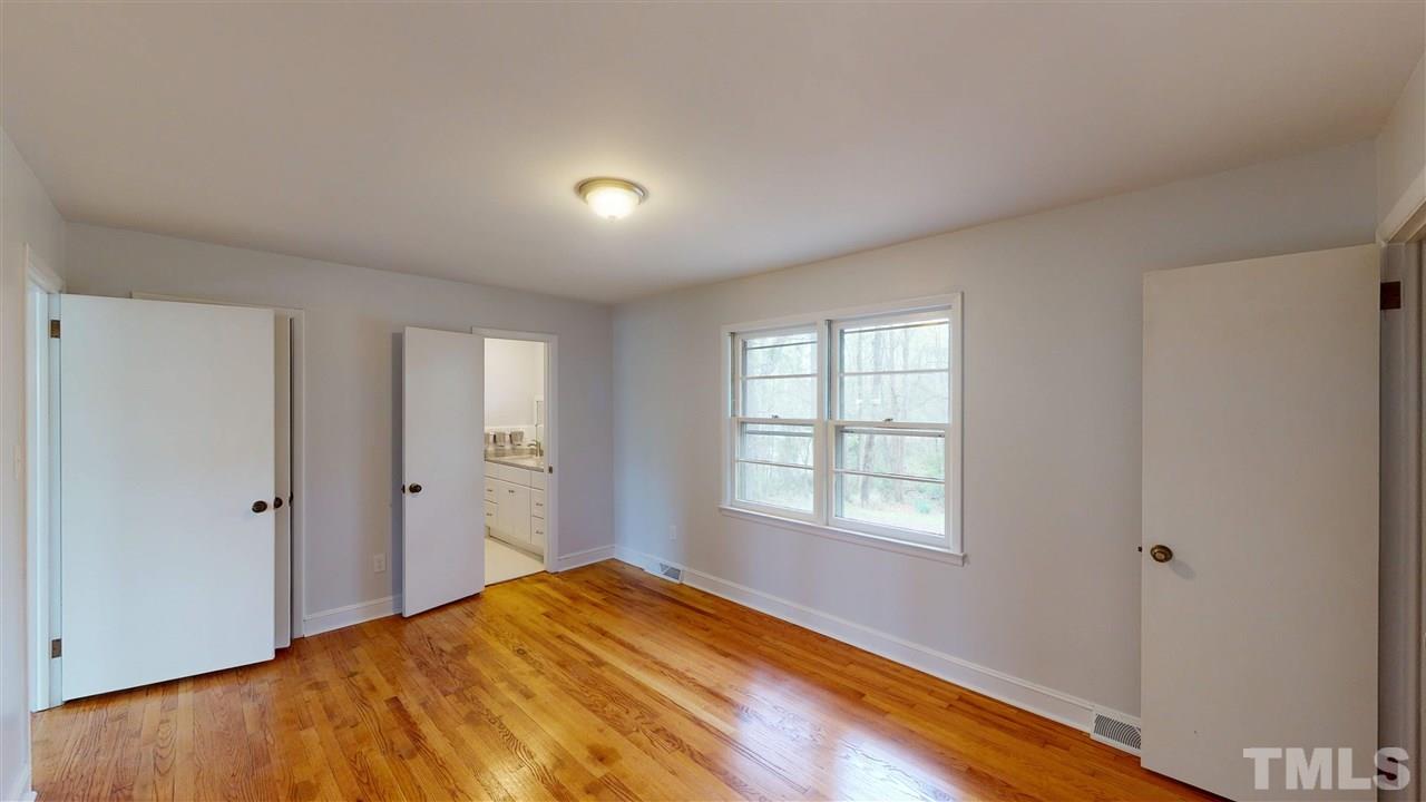 108 Rand Road Raleigh, NC 27603 - Photo 7 of 29 Comfortable Master retreat has 2 separate walk in closets. Windows look out on the extensive backyard and pond.