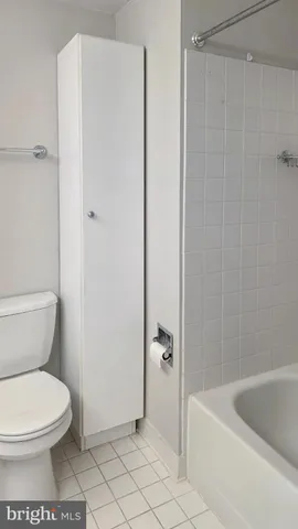 a bathroom with a toilet and bathtub