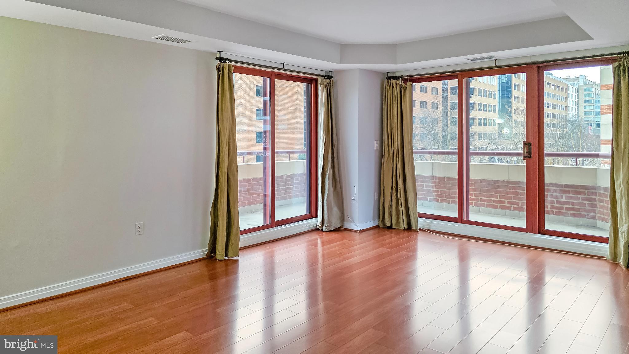 2301 N Street Northwest, Unit 404 Washington, DC 20037 - Photo 4 of 21 wooden floor in an empty room with a window