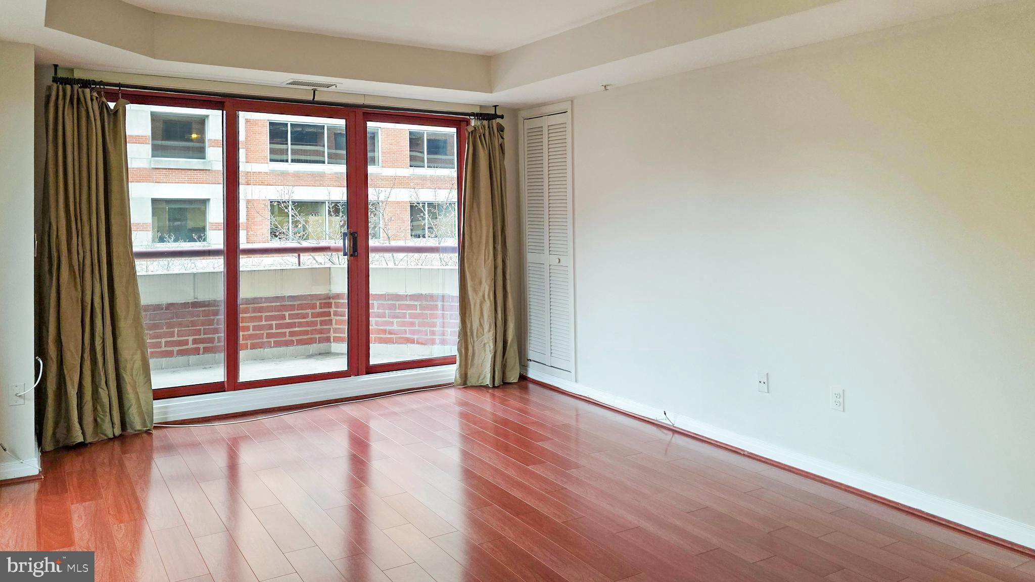 2301 N Street Northwest, Unit 404 Washington, DC 20037 - Photo 6 of 21 an empty room with wooden floor and windows