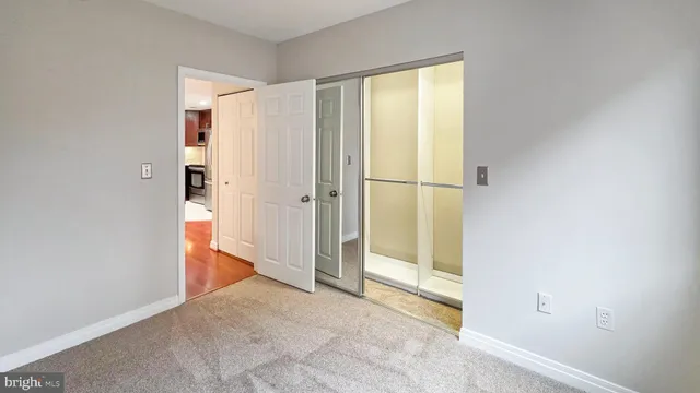 a view of empty room with wooden floor and cabinet
