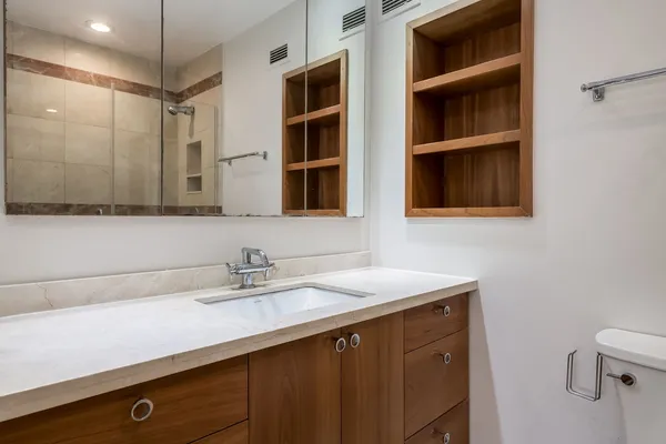 a bathroom with a sink a vanity and a mirror