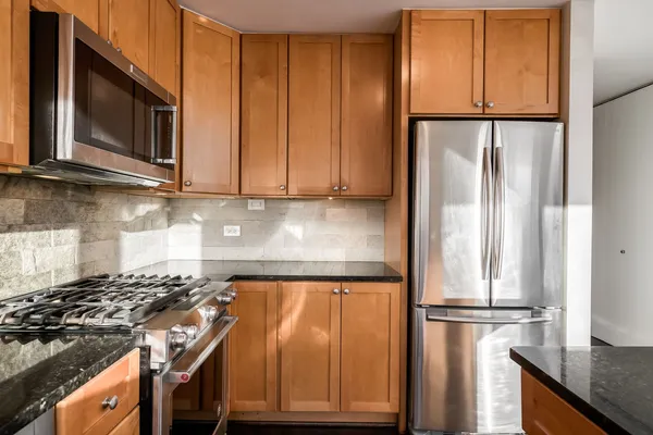 a kitchen with a refrigerator stove and microwave