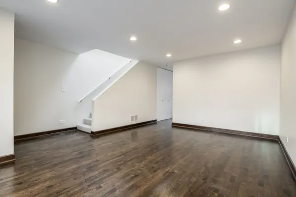 an empty room with wooden floor