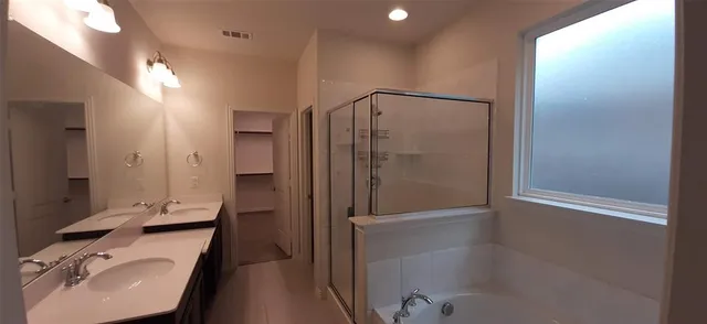 a bathroom with a bathtub and a sink