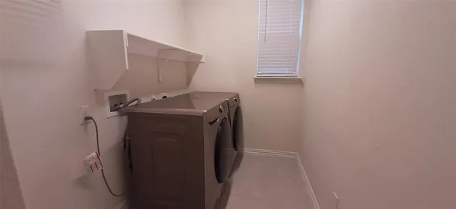 a utility room with a sink dryer and washer