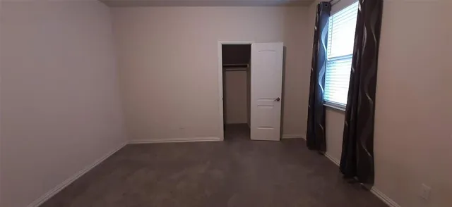 an empty room that has a window in it