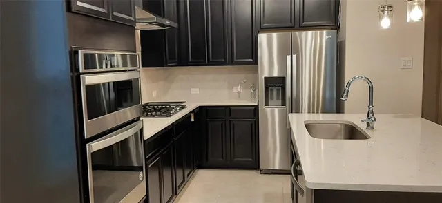 a kitchen with a refrigerator and a sink