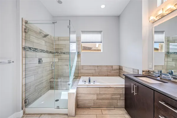 a bathroom with a bathtub and a shower