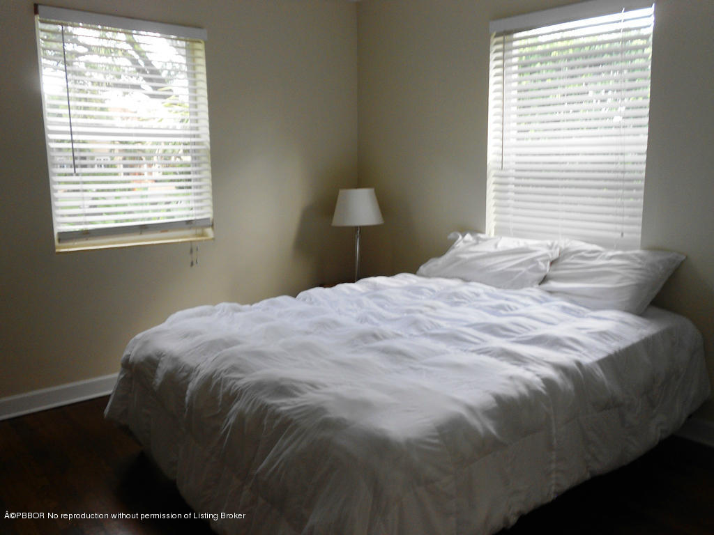 314 Westminster Road West Palm Beach, FL 33405 - Photo 4 of 9 a bed sitting in a bedroom next to a window